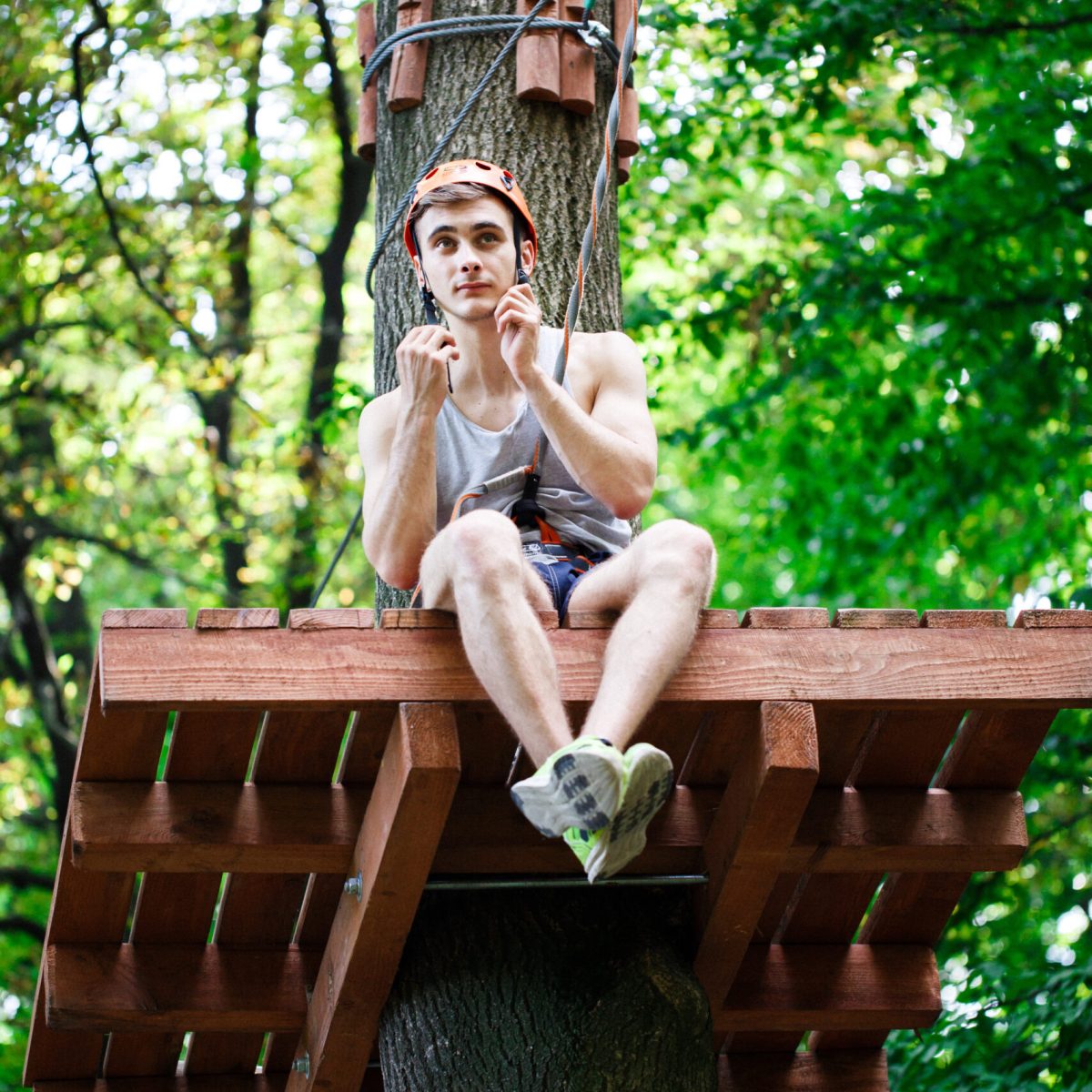 Tired man sits on the tree